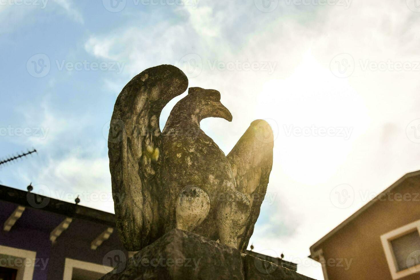 a statue of an eagle on top of a building photo