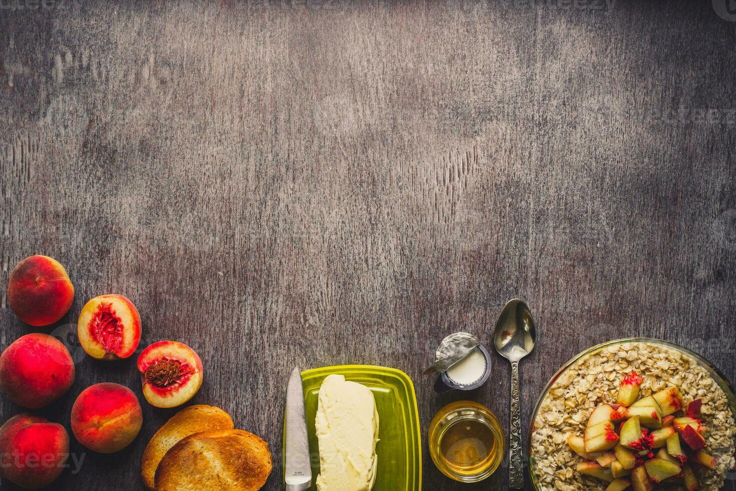 Ingredients for oatmeal on dark wooden table. Concept of healthy food. Top view, copy space. Toned photo