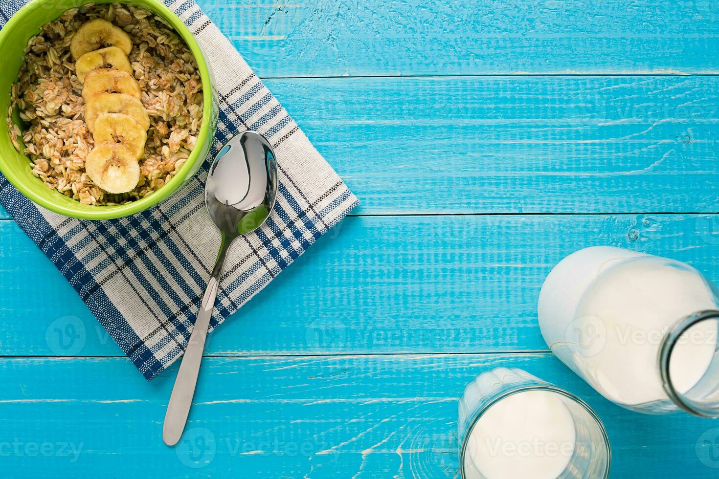 Porridge, oats, milk and banana on the table photo