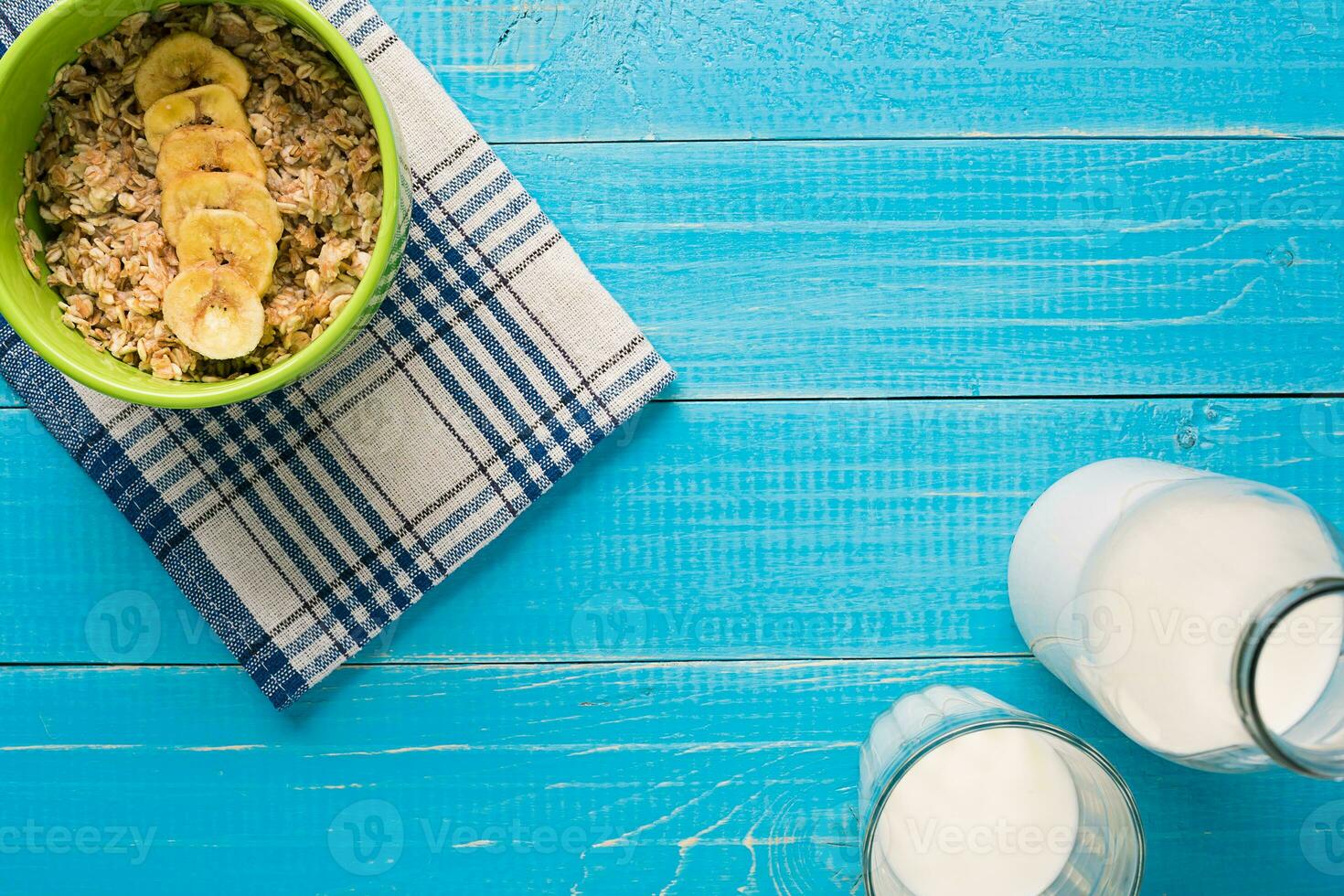 Porridge, oats, milk and banana on the table photo