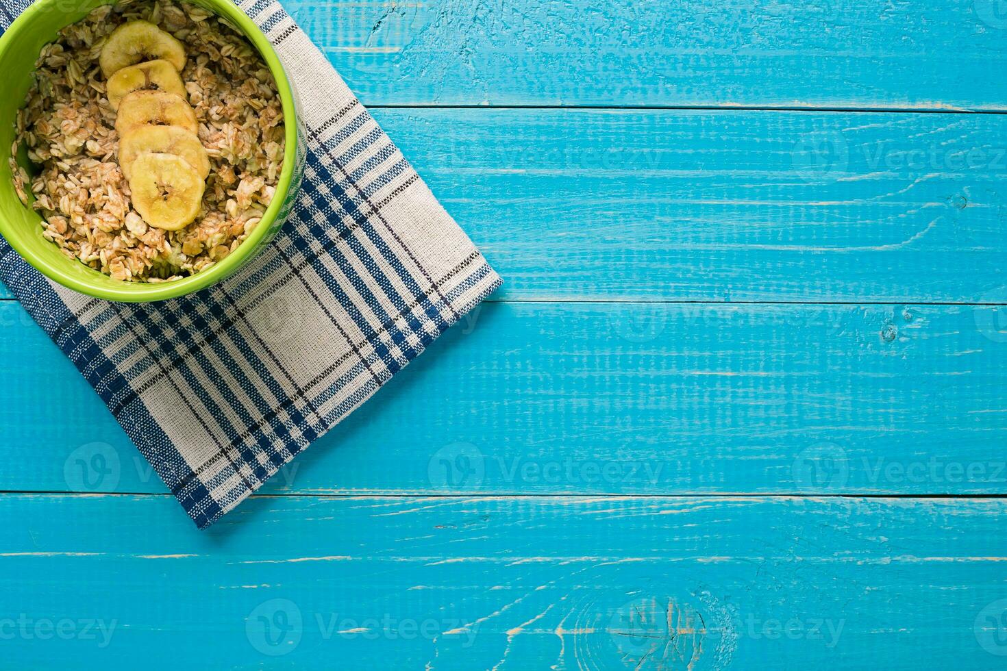 Porridge, oats, milk and banana on the table photo