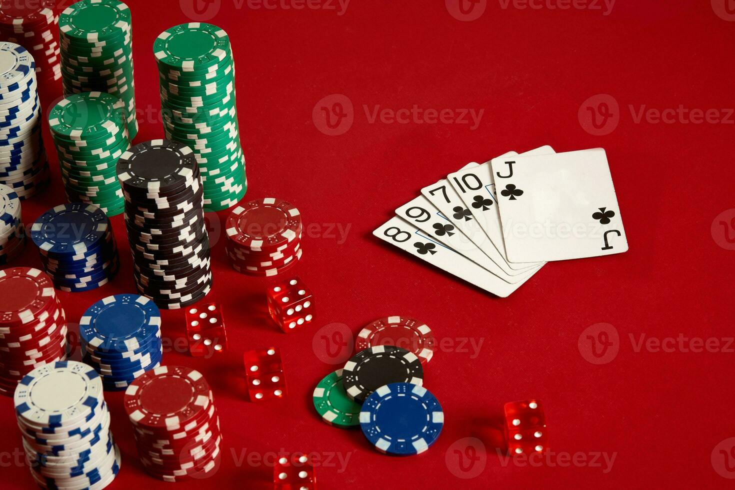 Casino gambling poker equipment and entertainment concept - close up of playing cards and chips at red background. Straight Flush photo