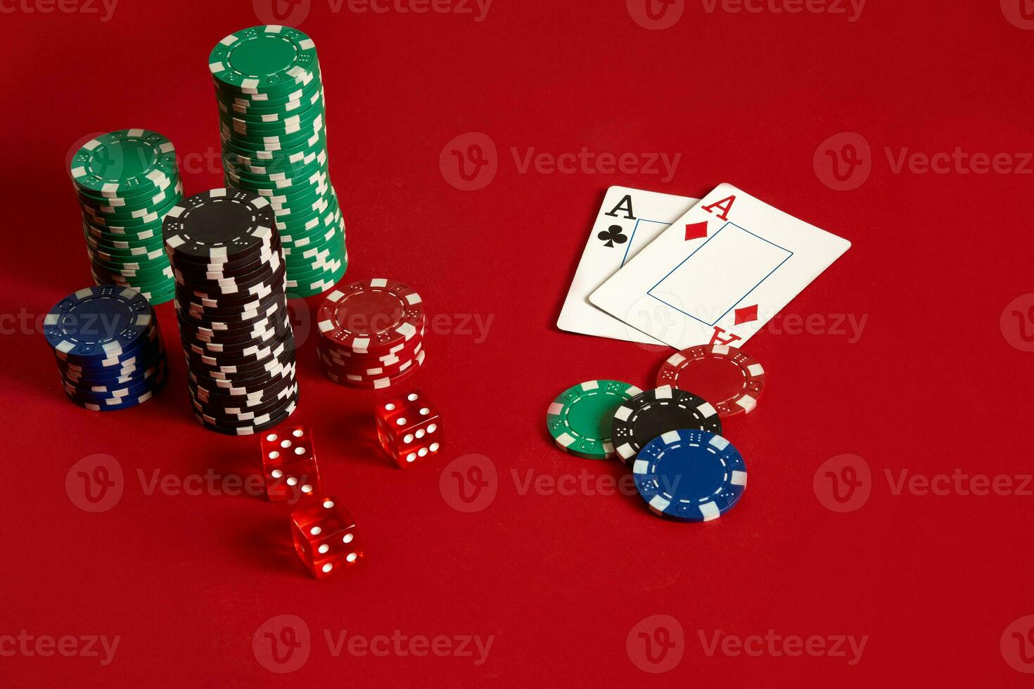 Poker chips and aces on red background. Group of different poker chips. Casino background. photo