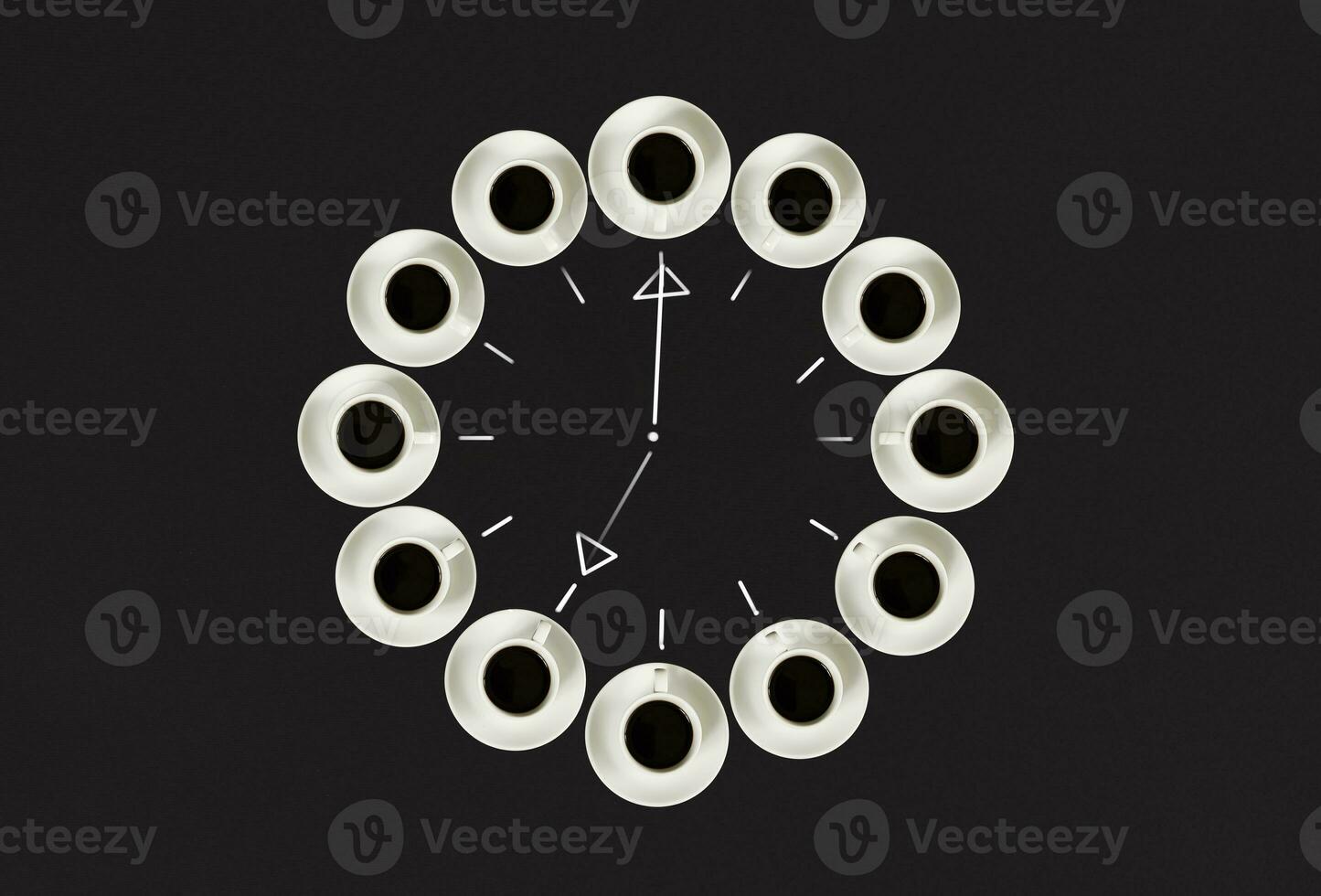 Cups with coffee, stacked in a circle. Clock consist of twenty cups. Black background. Concept time to coffee photo