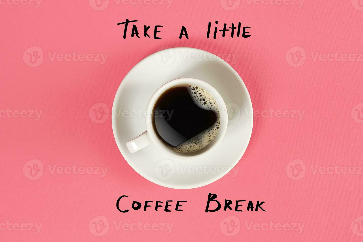 Top view of cup of black coffee and Take a little coffee break lettering isolated on pink background photo