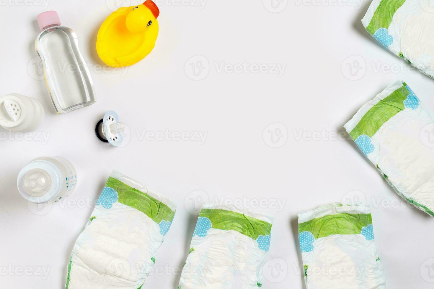Babies goods diaper, baby powder, cream, shampoo, oil on white background with copy space. Top view or flat lay. photo
