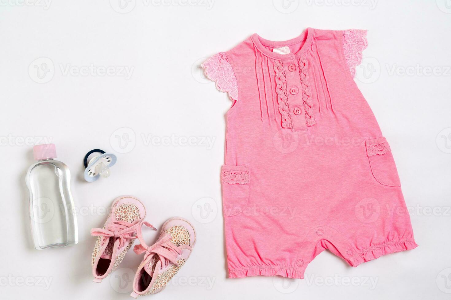 Baby clothes and accessories on white background. Top view photo