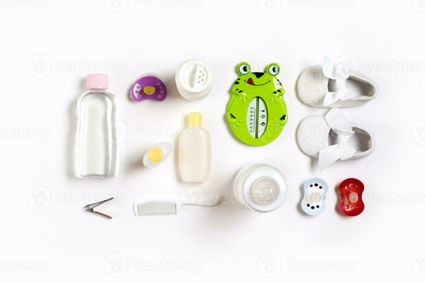 Hairbrush and cosmetics for newborns on a white background. Top view photo