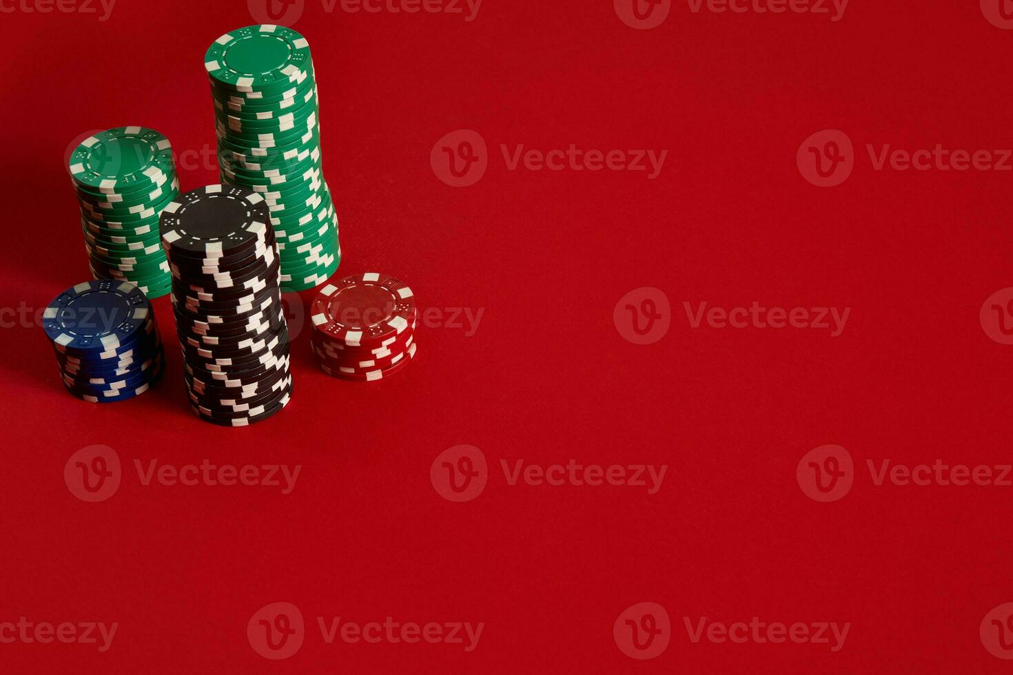 Poker chips on red background. Group of different poker chips. Casino background. photo