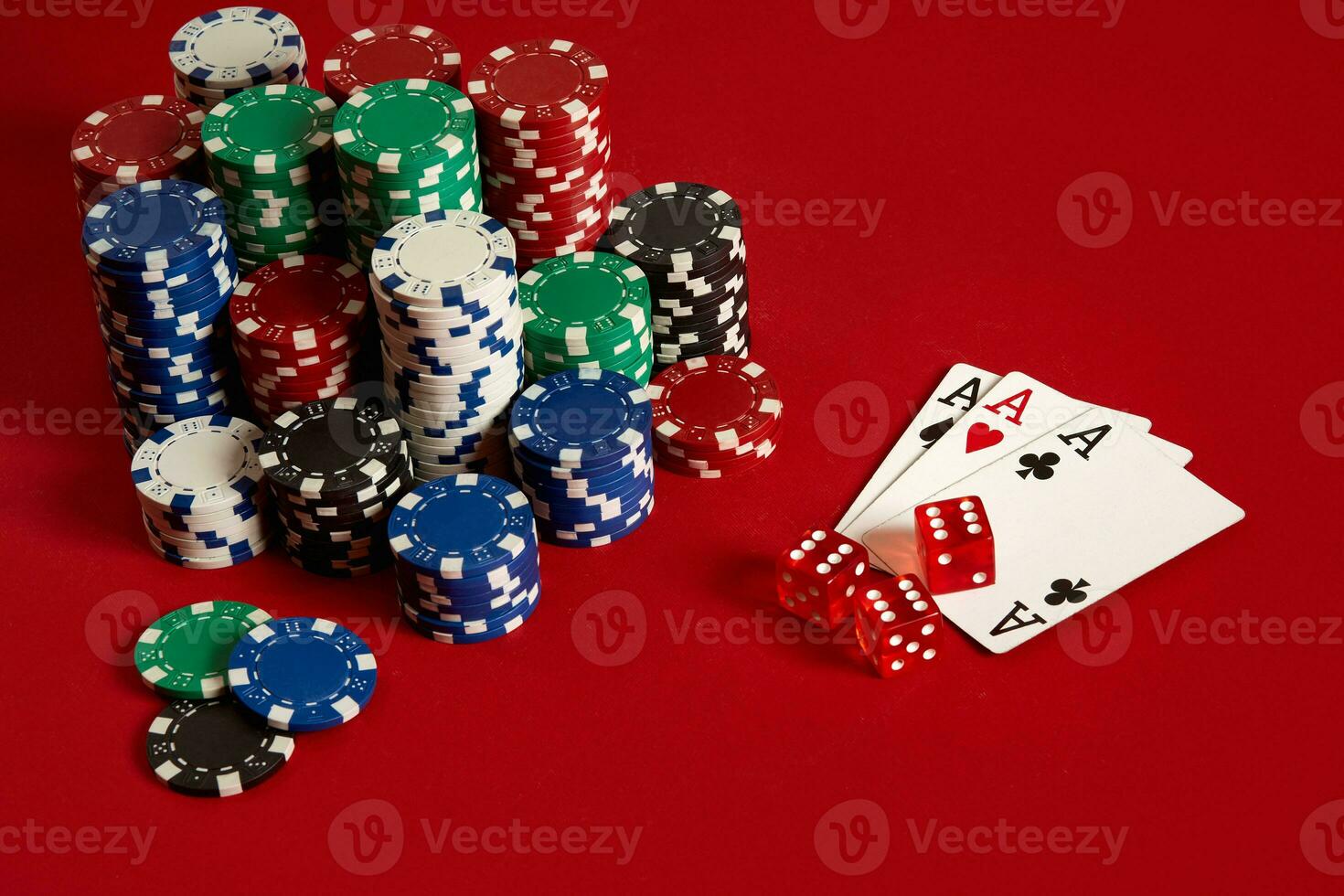 Casino gambling poker equipment and entertainment concept - close up of playing cards and chips at red background. Three of a Kind photo