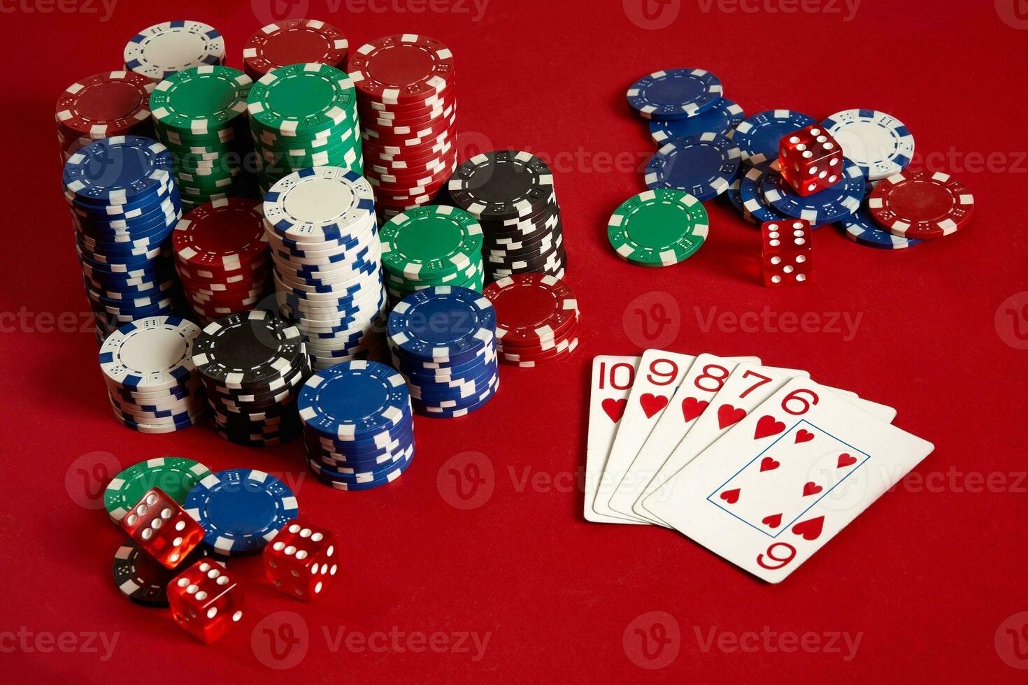 Casino gambling poker equipment and entertainment concept - close up of playing cards and chips at red background. Straight Flush photo