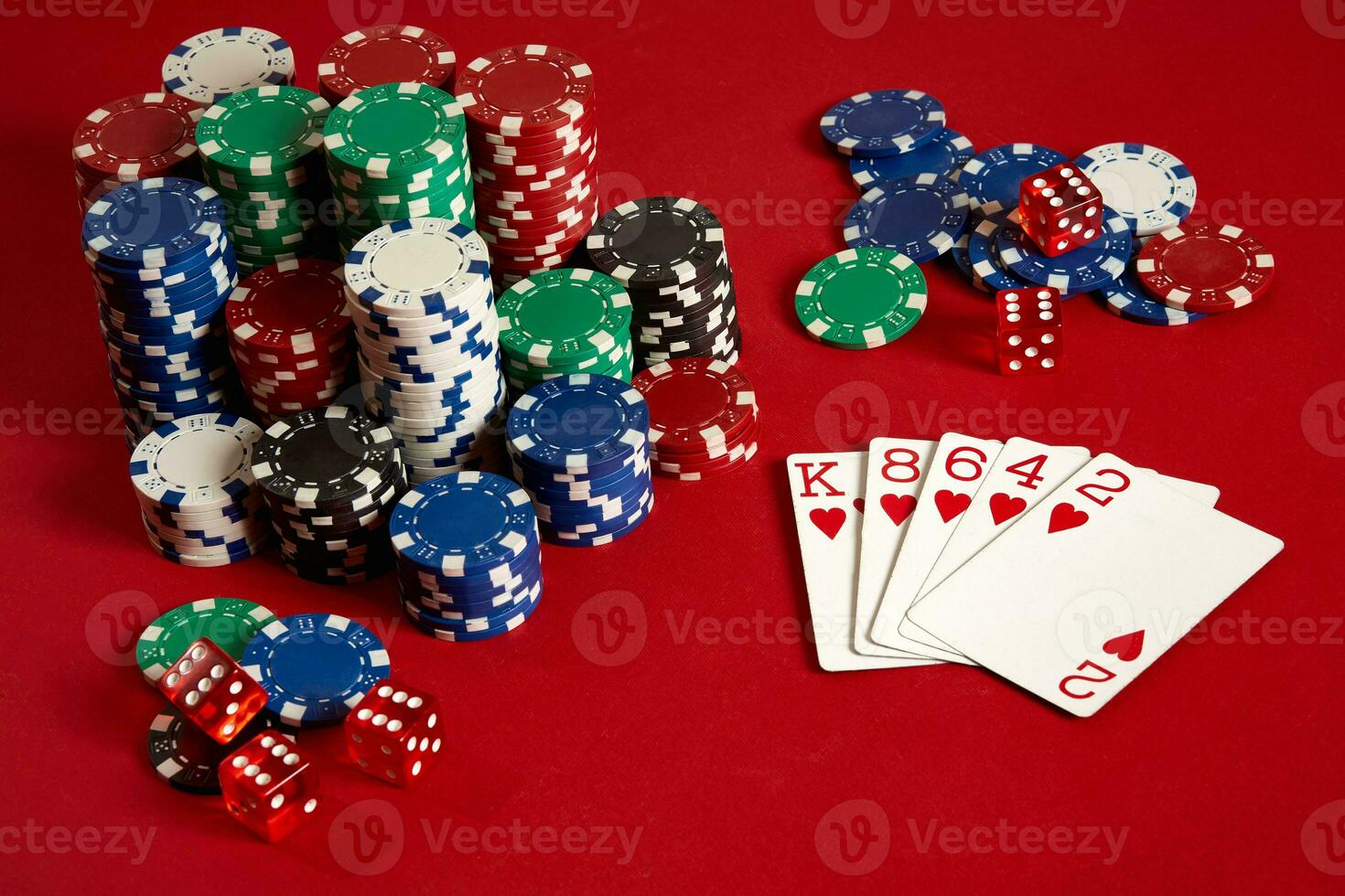 Casino gambling poker equipment and entertainment concept - close up of playing cards and chips at red background. Flush photo