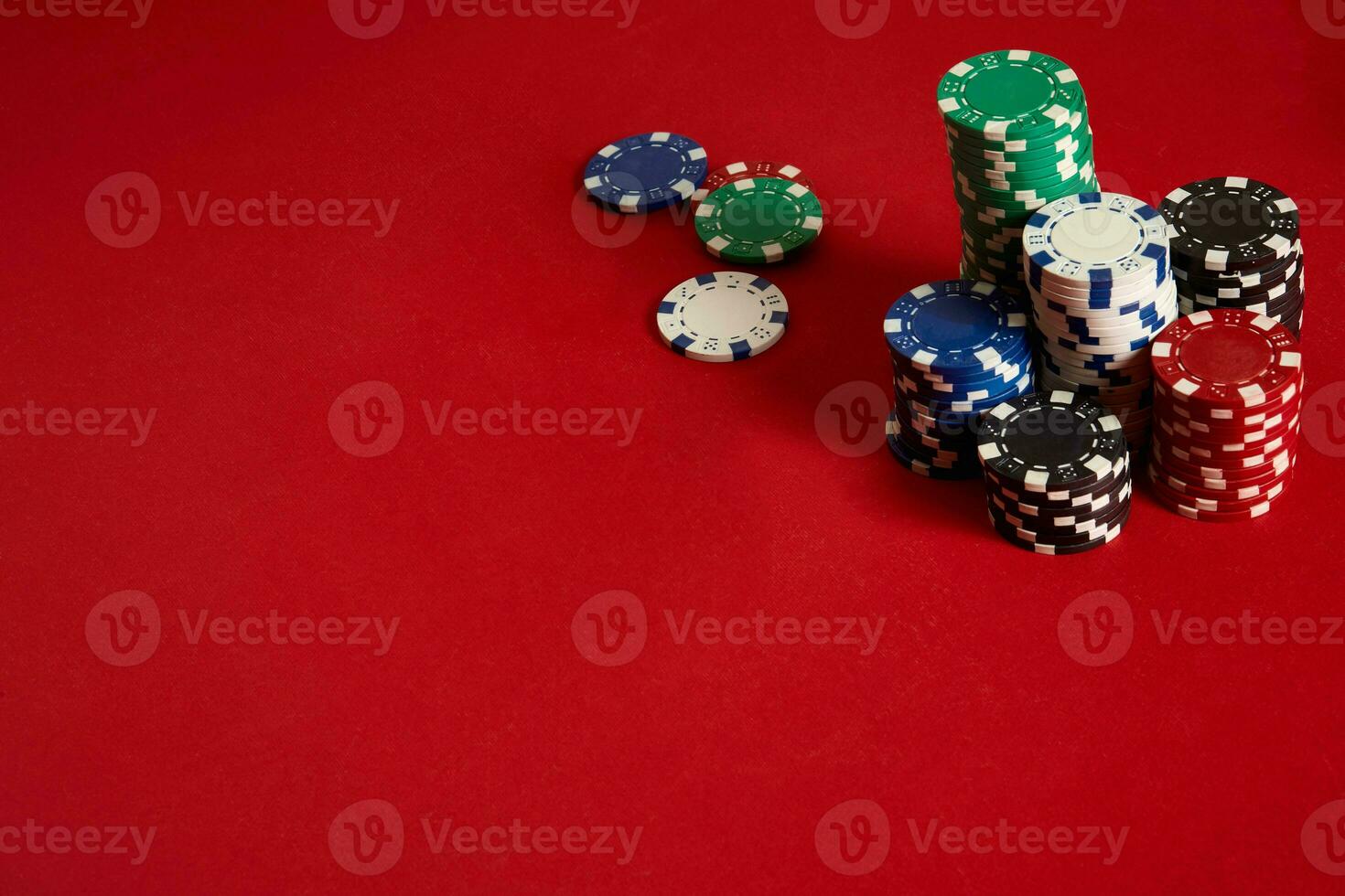 Poker chips on red background. Group of different poker chips. Casino background. photo