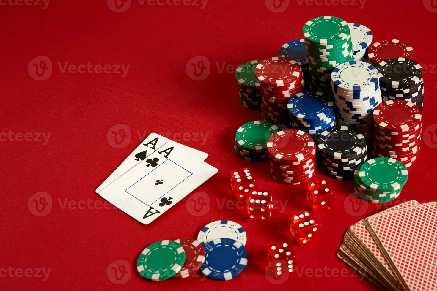 Poker chips and aces on red background. Group of different poker chips. Casino background. photo