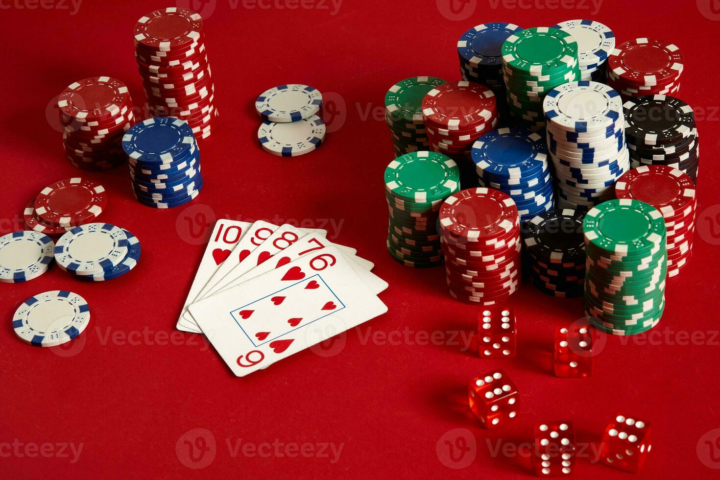 Casino gambling poker equipment and entertainment concept - close up of playing cards and chips at red background. Straight Flush photo