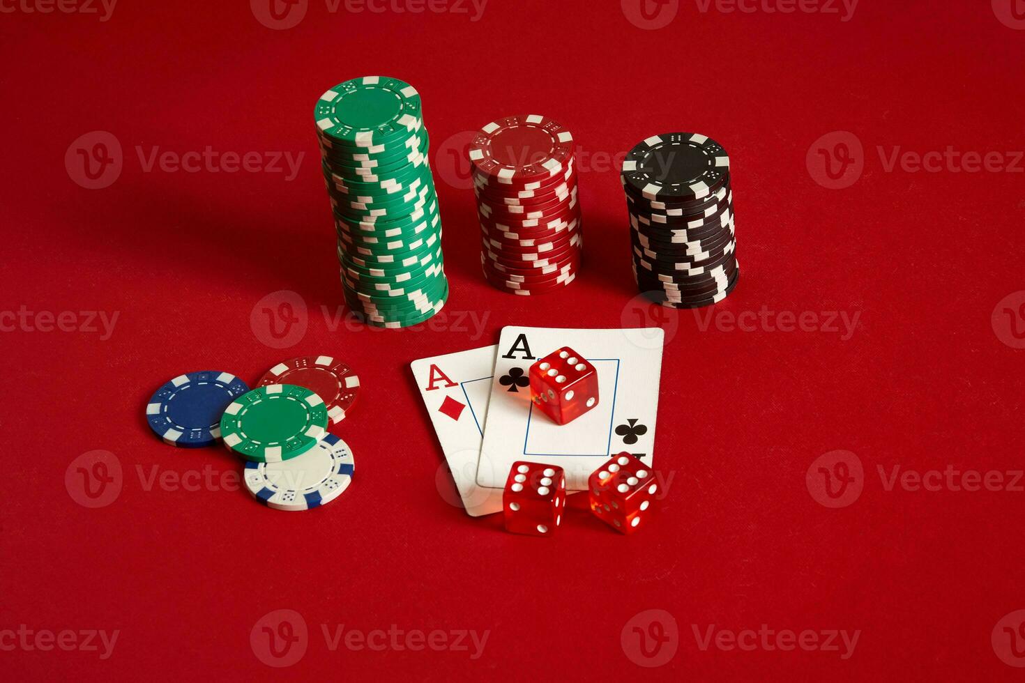 Poker chips and aces on red background. Group of different poker chips. Casino background. photo