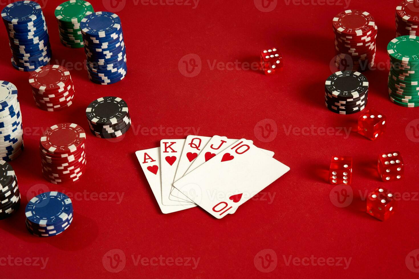 Poker cards and gambling chips on red background photo