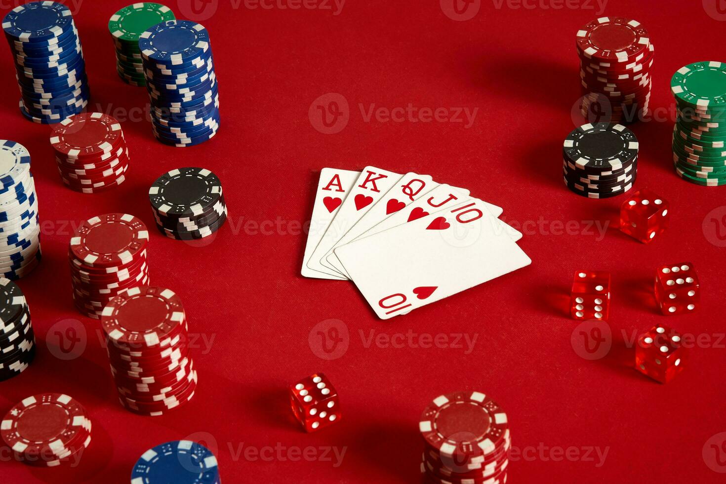 Poker cards and gambling chips on red background photo
