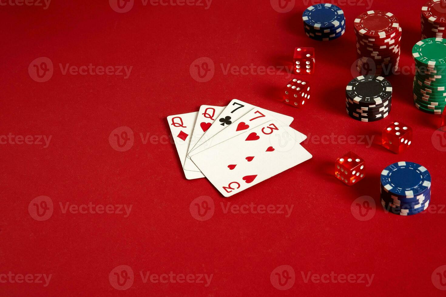 Poker cards and gambling chips on red background photo