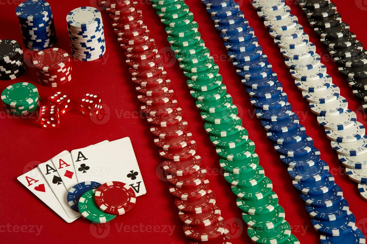 Poker cards and gambling chips on red background photo
