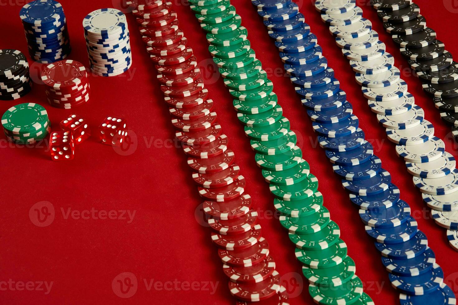 Stack of poker chips on red background at casino photo