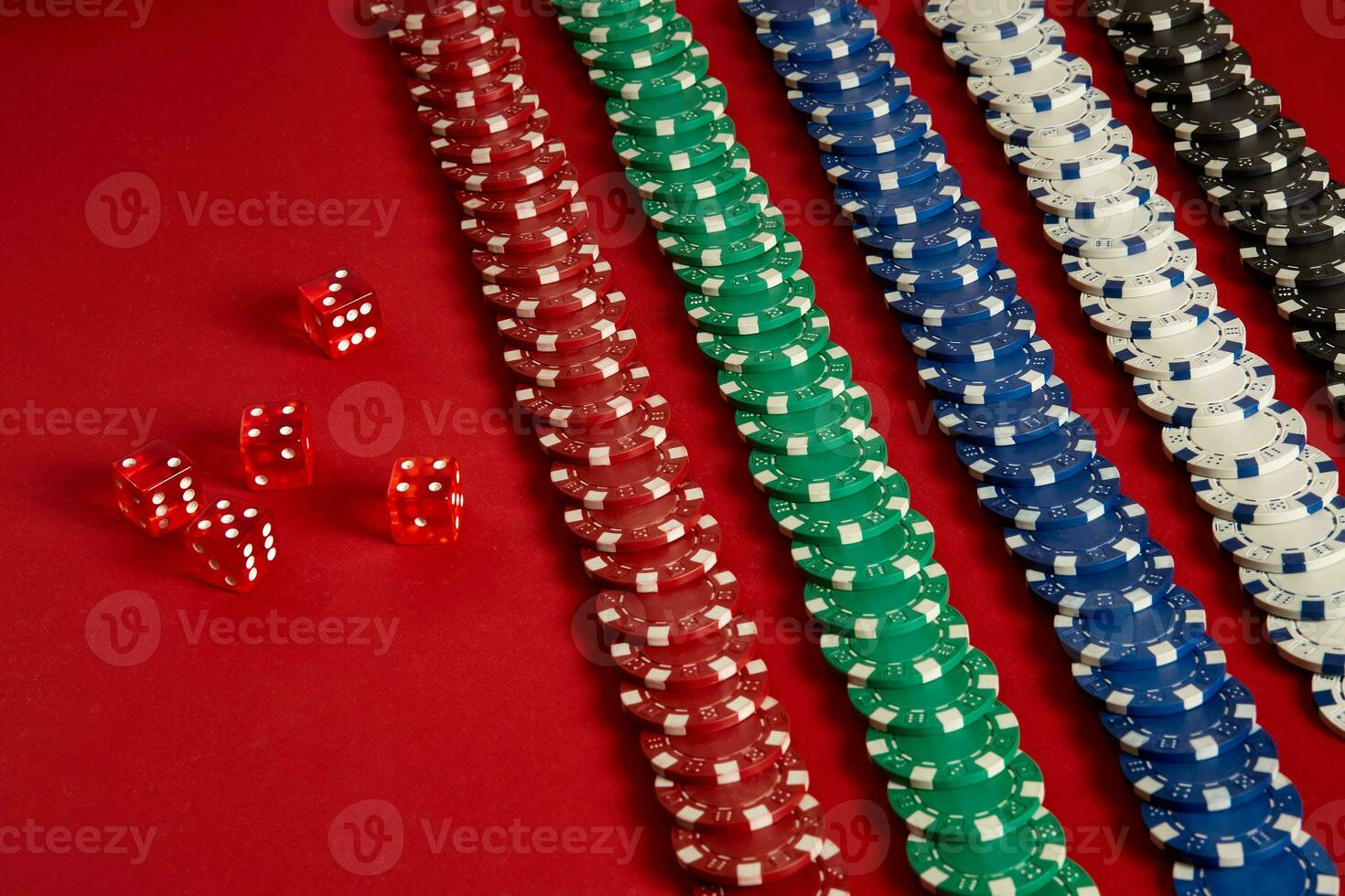 Stack of poker chips on red background at casino photo
