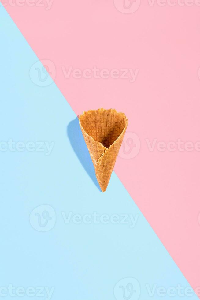Sugar waffle cone for ice cream arranged in pattern on pink and mint background. The image with copy space can be used as a background for the design of the confectionery menu photo