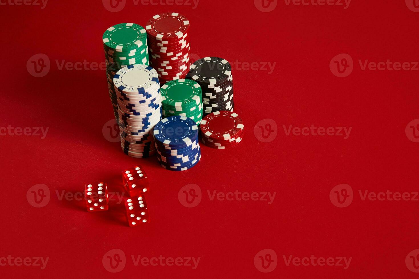 Poker chips on red background. Group of different poker chips. Casino background. photo