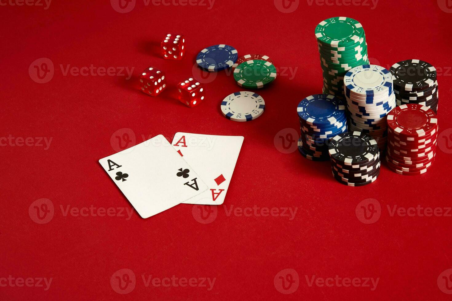 Poker chips and aces on red background. Group of different poker chips. Casino background. photo