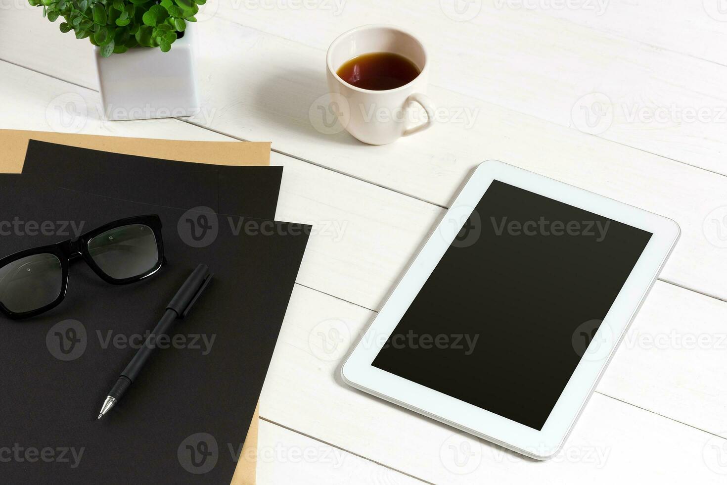 Modern workplace with digital tablet computer and mobile phone, cup of coffee, pen and empty sheet of paper. photo