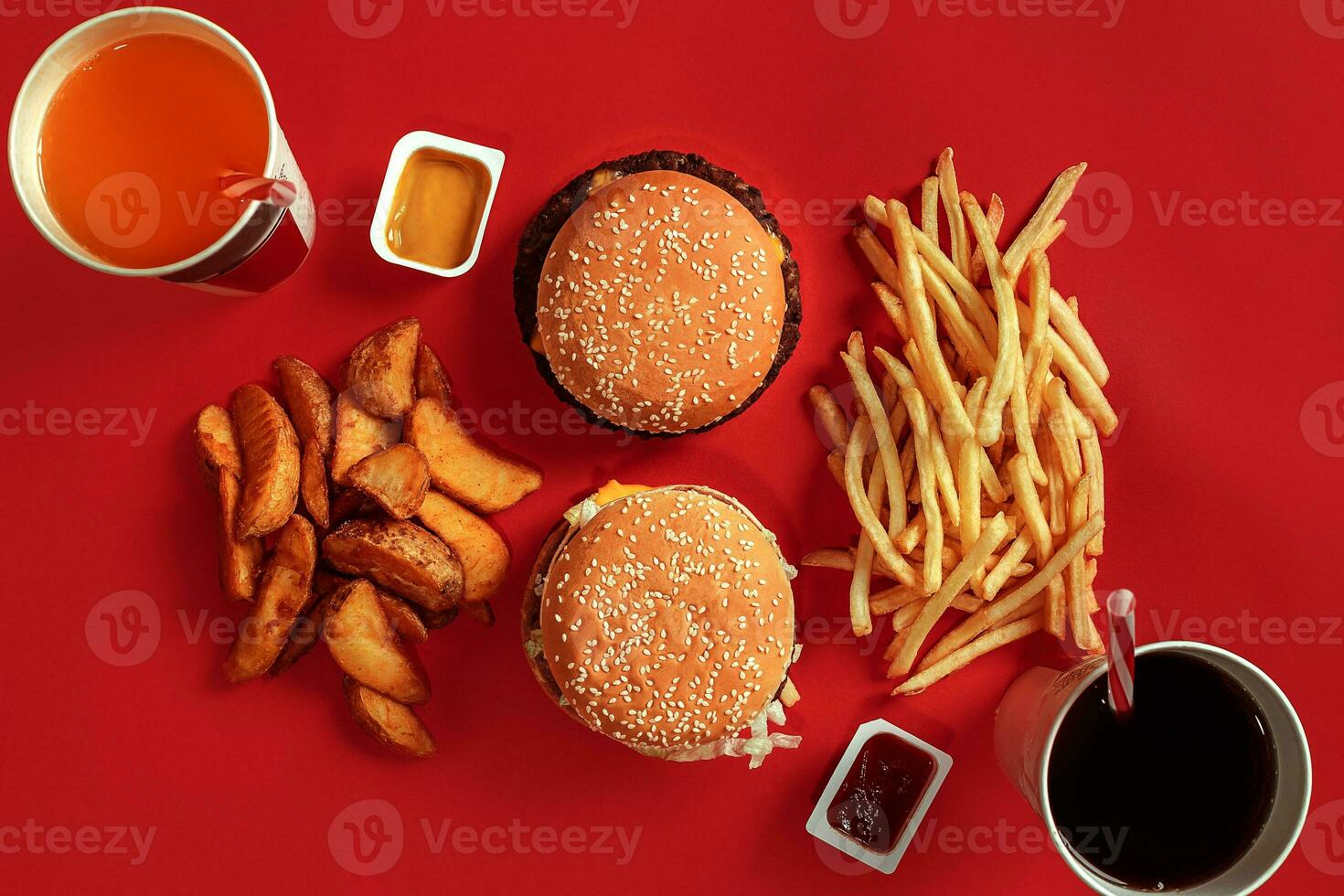 Burger and Chips. Hamburger and french fries in red paper box. Fast food on red background. photo