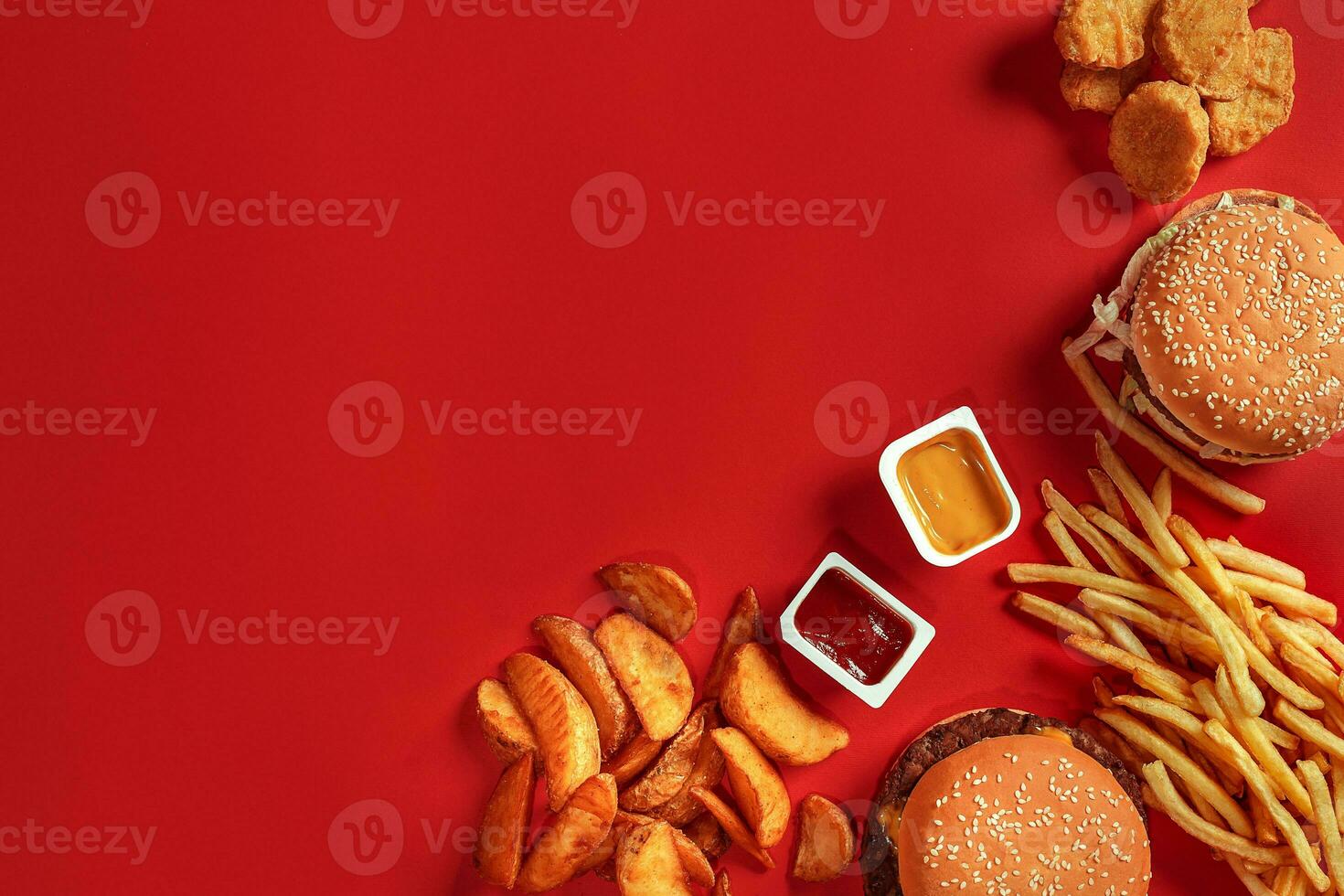 Burger and Chips. Hamburger and french fries in red paper box. Fast food on red background. photo