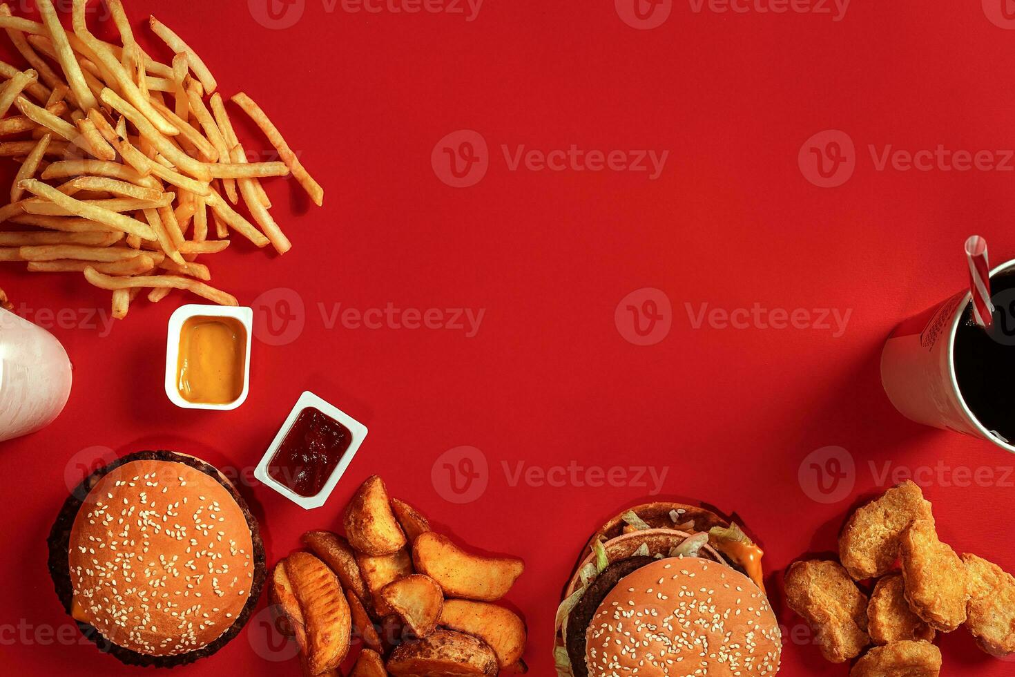 Fast food dish top view. Meat burger, potato chips and glass of drink on red background. Takeaway composition. photo