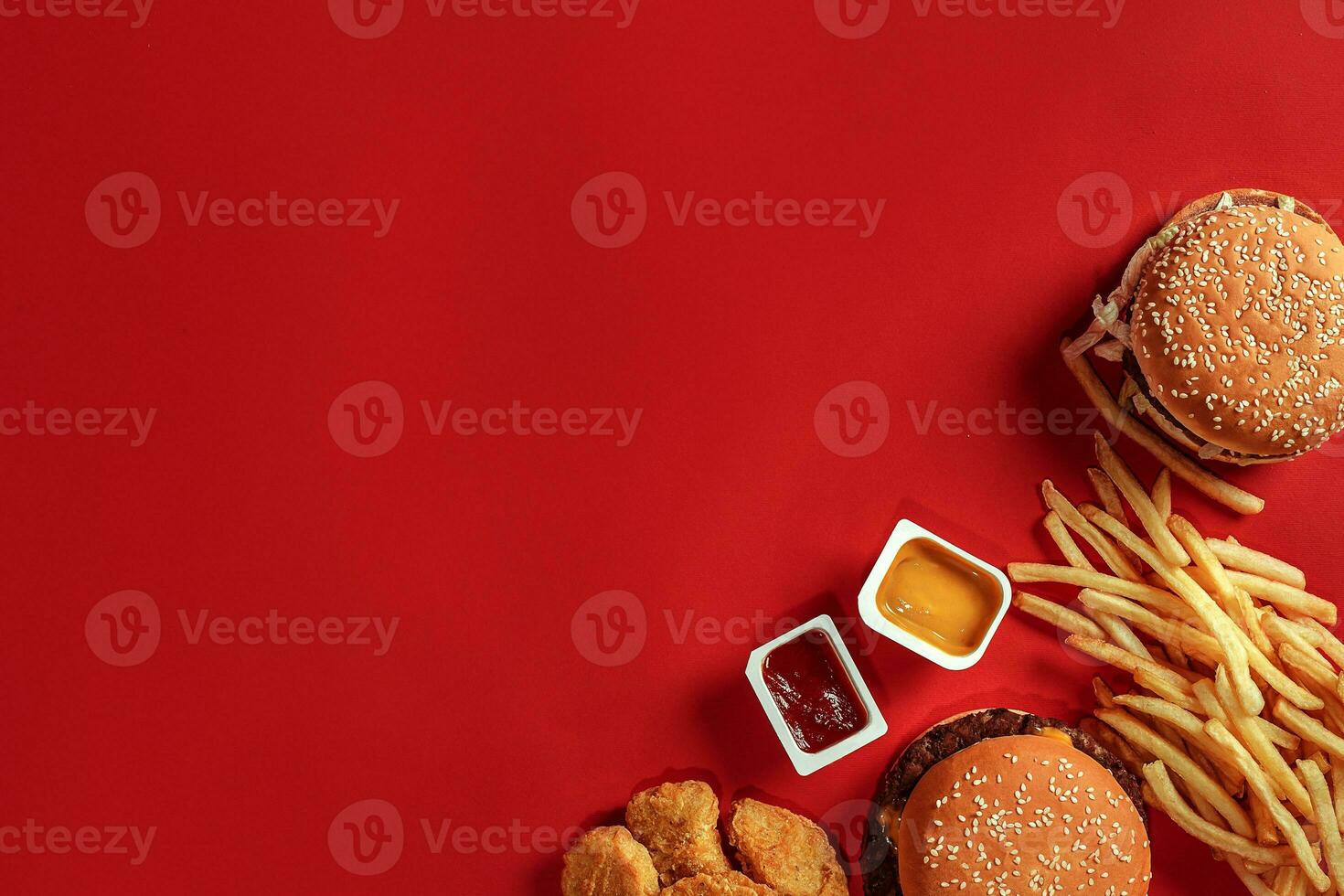 Burger and Chips. Hamburger and french fries in red paper box. Fast food on red background. photo