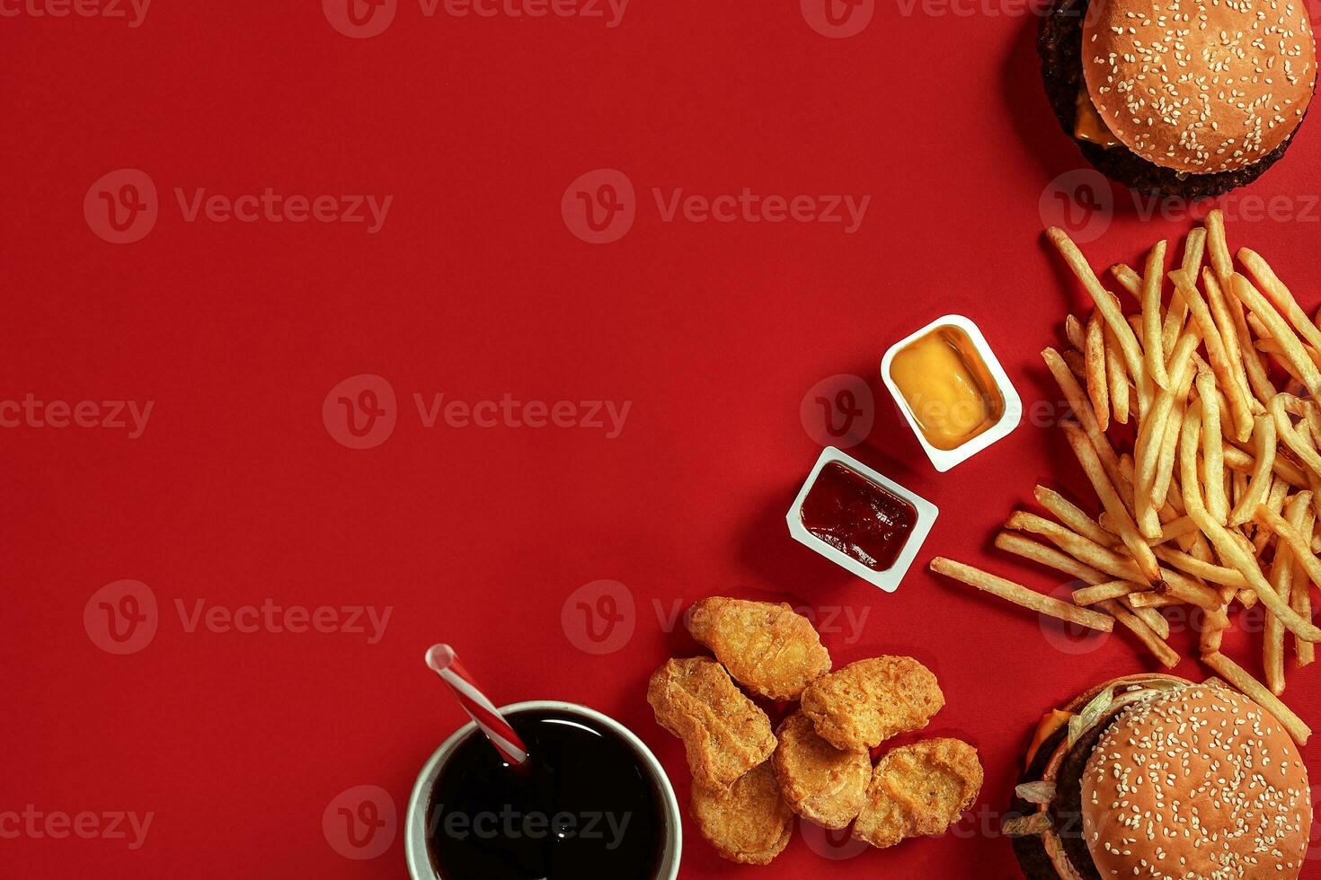 Burger and Chips. Hamburger and french fries in red paper box. Fast food on red background. photo