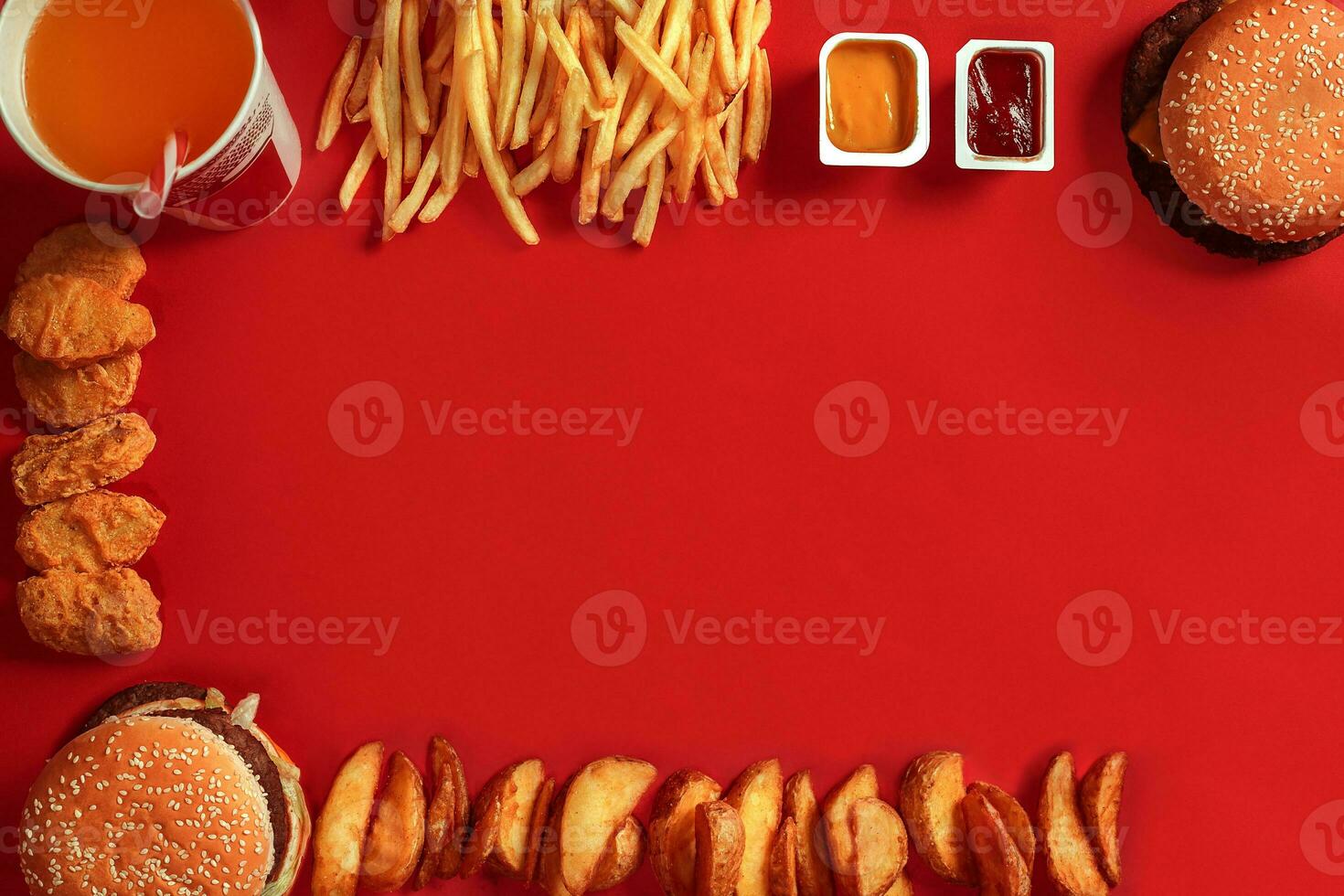 Fast food dish top view. Meat burger, potato chips and glass of drink on red background. Takeaway composition. photo