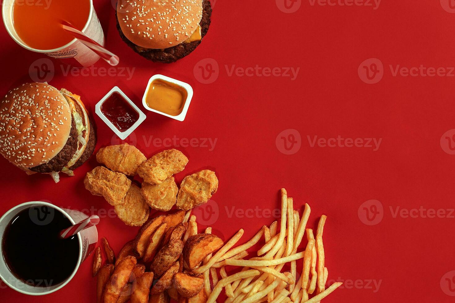 Burger and Chips. Hamburger and french fries in red paper box. Fast food on red background. photo