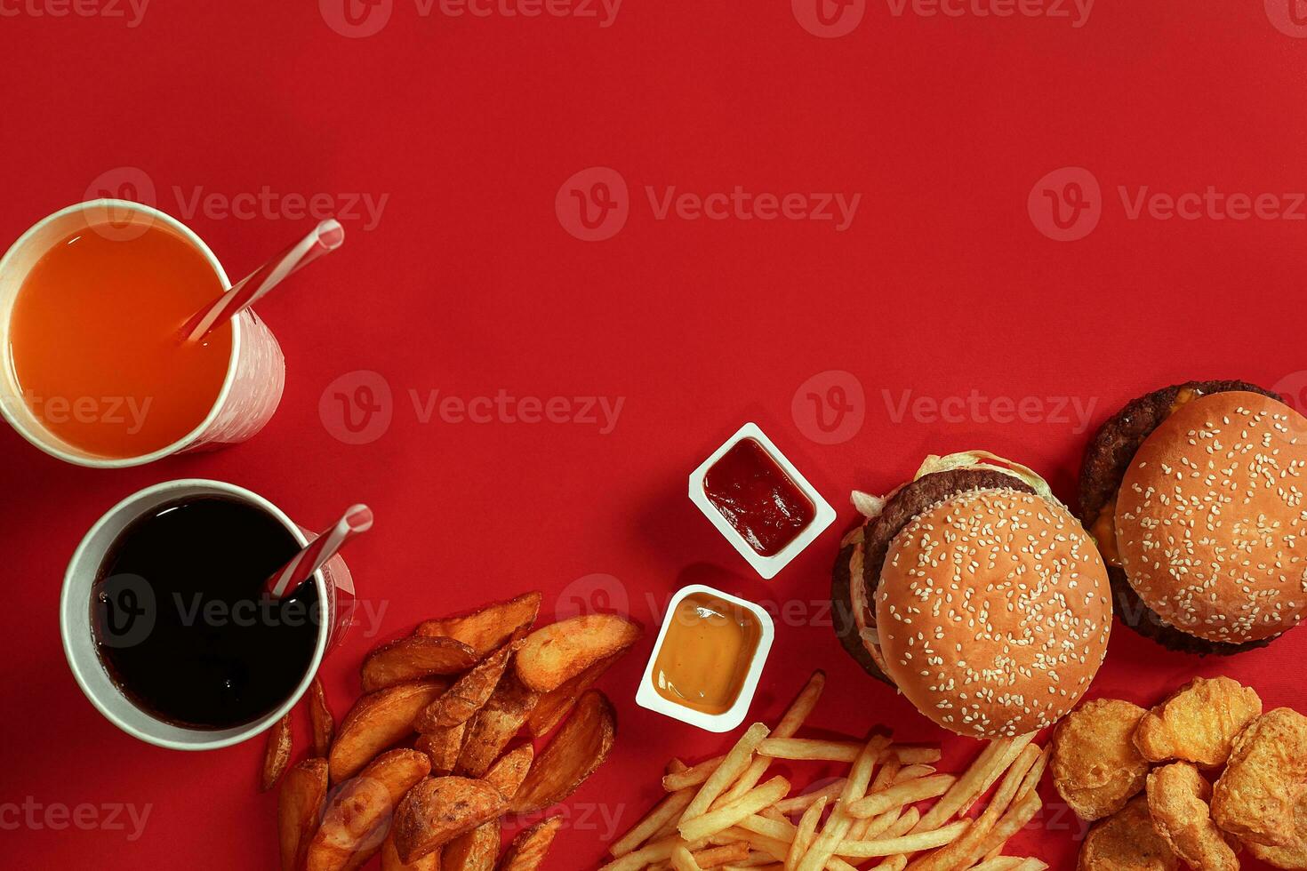 Burger and Chips. Hamburger and french fries in red paper box. Fast food on red background. photo