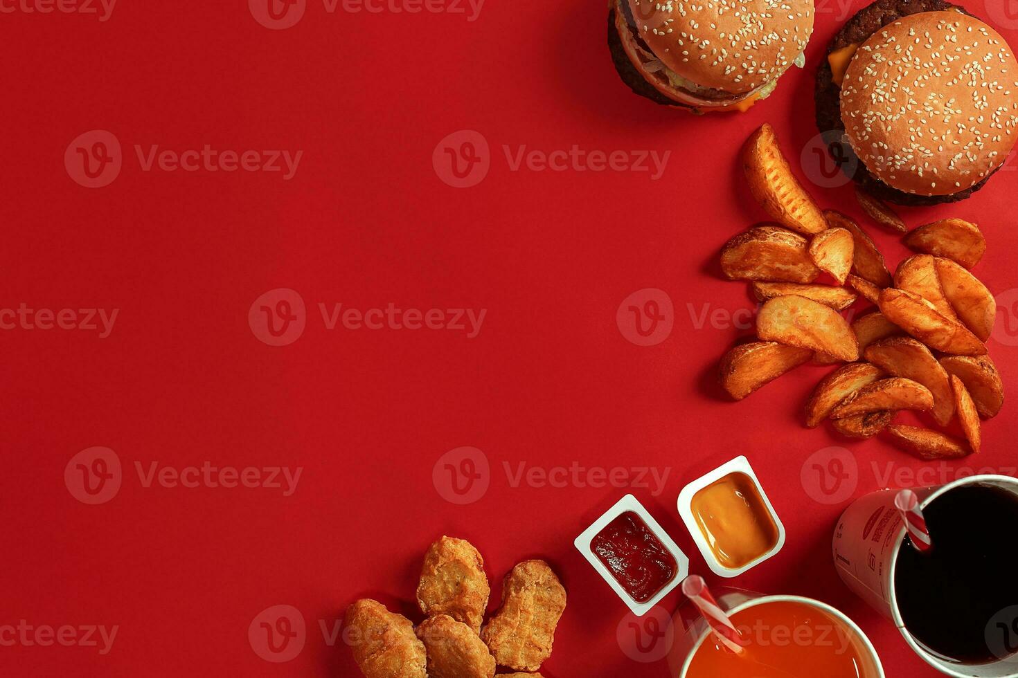 Burger and Chips. Hamburger and french fries in red paper box. Fast food on red background. photo