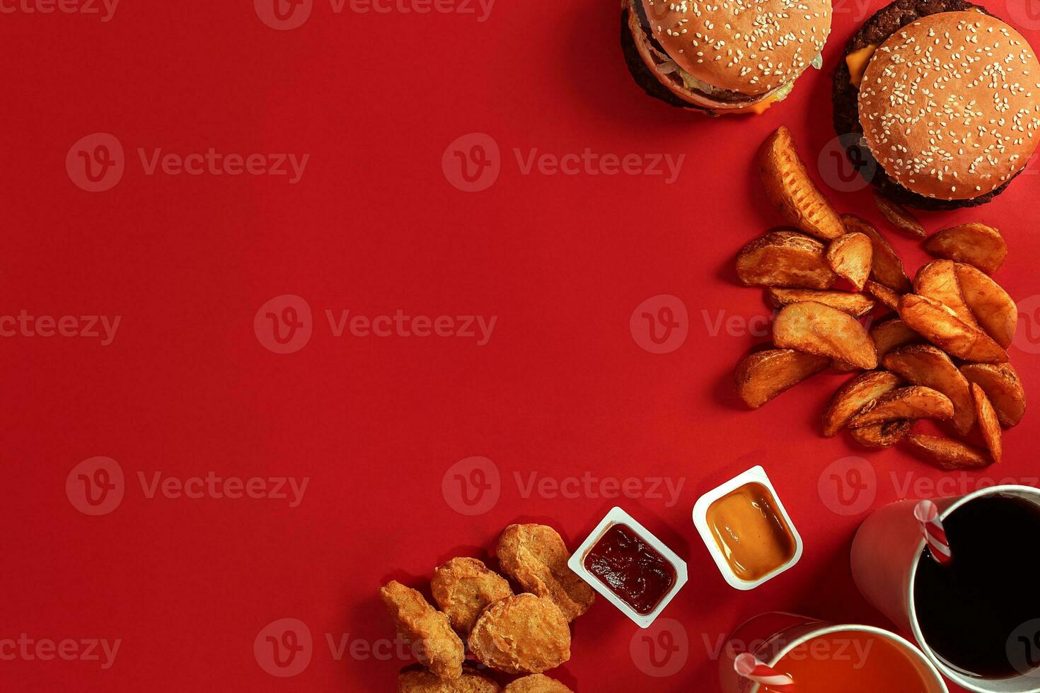 Burger and Chips. Hamburger and french fries in red paper box. Fast food on red background. photo