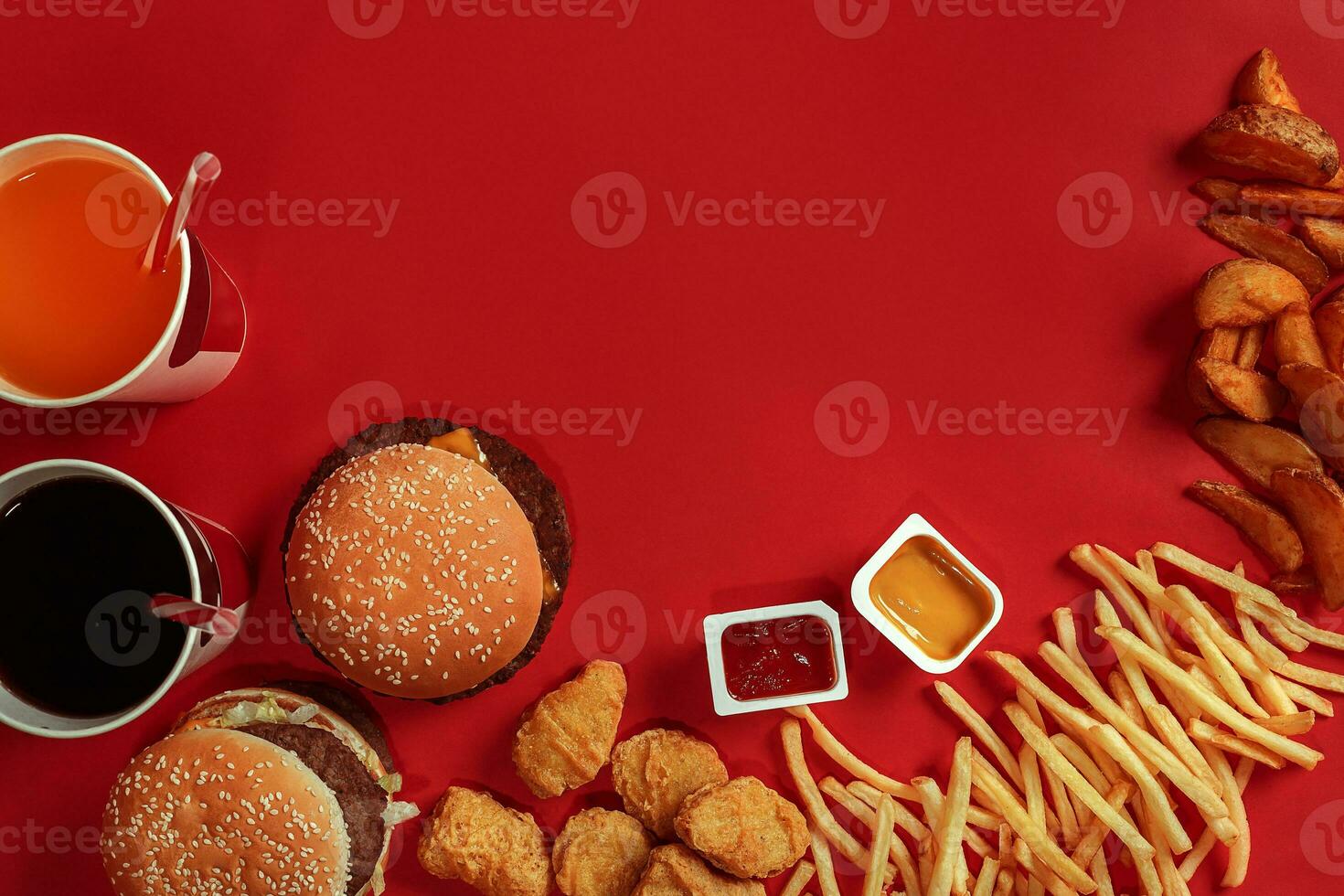 Burger and Chips. Hamburger and french fries in red paper box. Fast food on red background. photo