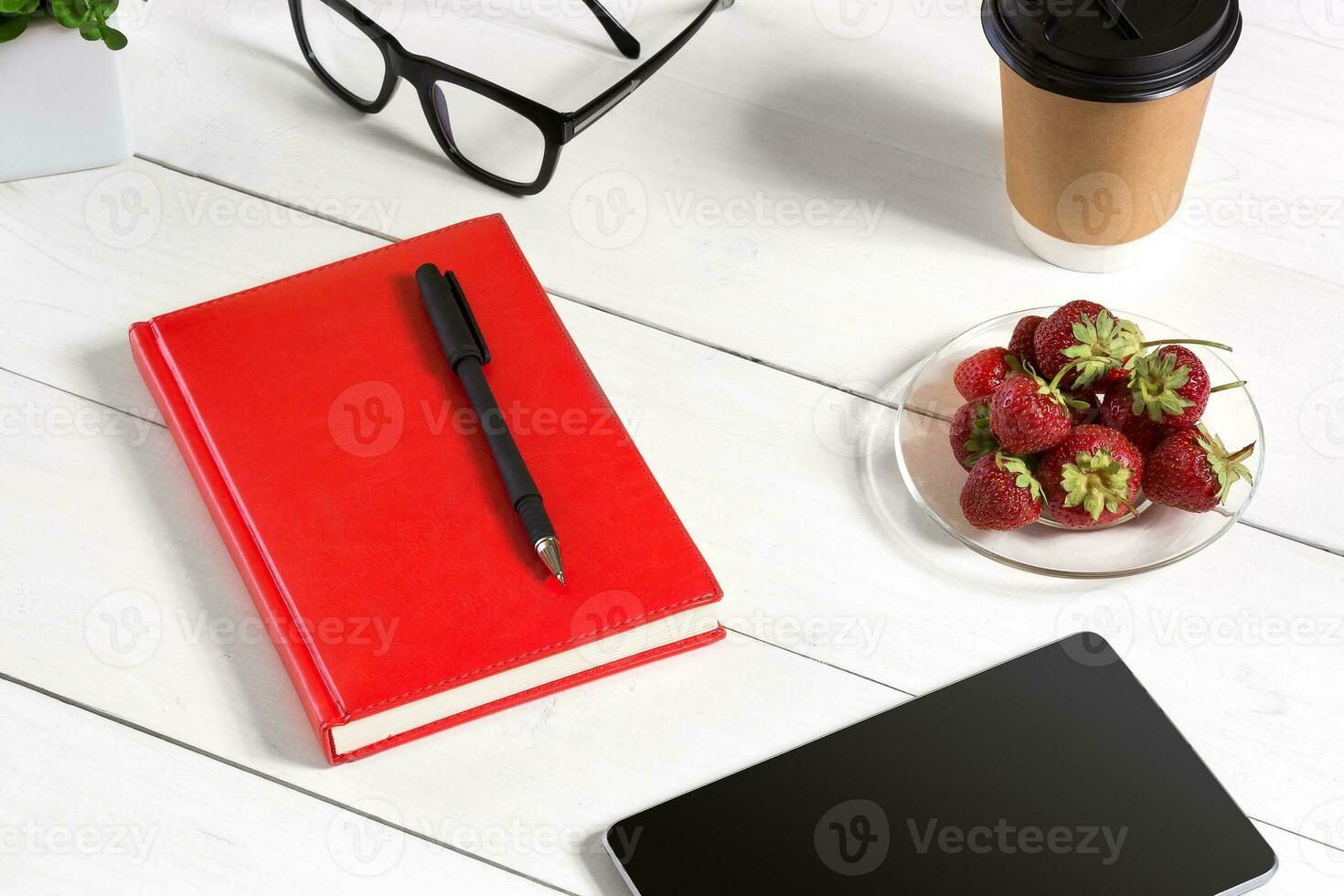 Stylish minimalistic workplace with tablet and notebook and glasses in flat lay style. White background. photo