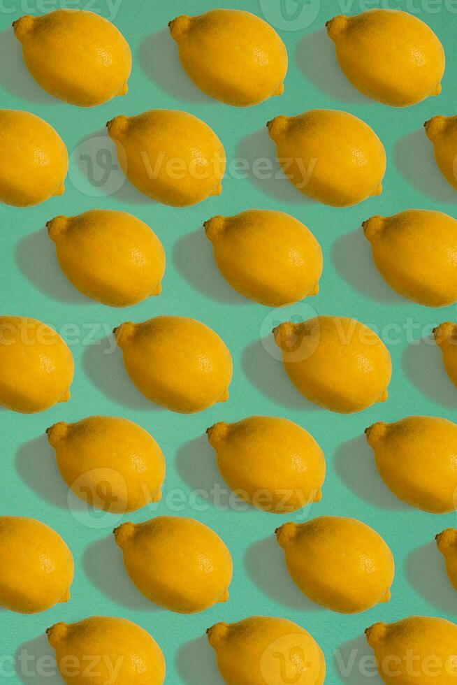 Lemon pattern isolated on blue background. Flat lay photo