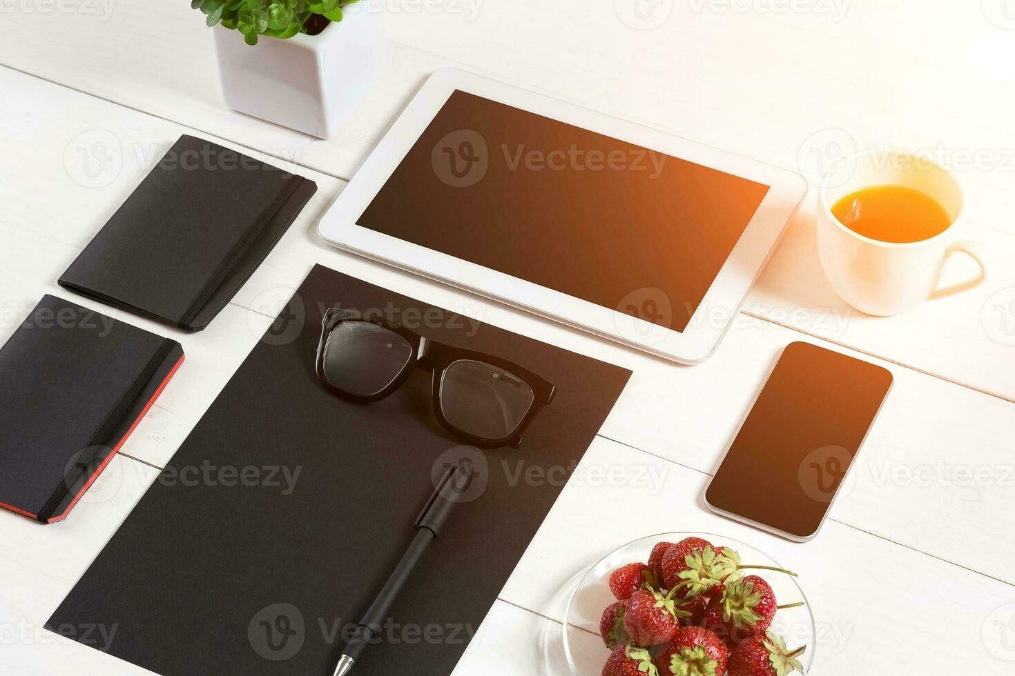 Modern workplace with digital tablet computer and mobile phone, cup of coffee, pen and empty sheet of paper. photo