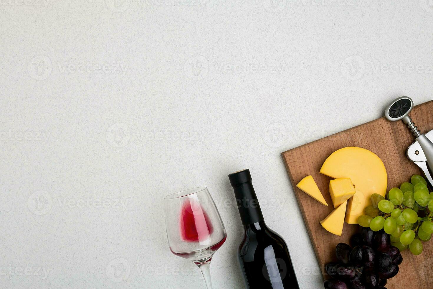 Glass of red wine, cheese and grapes. Top view photo