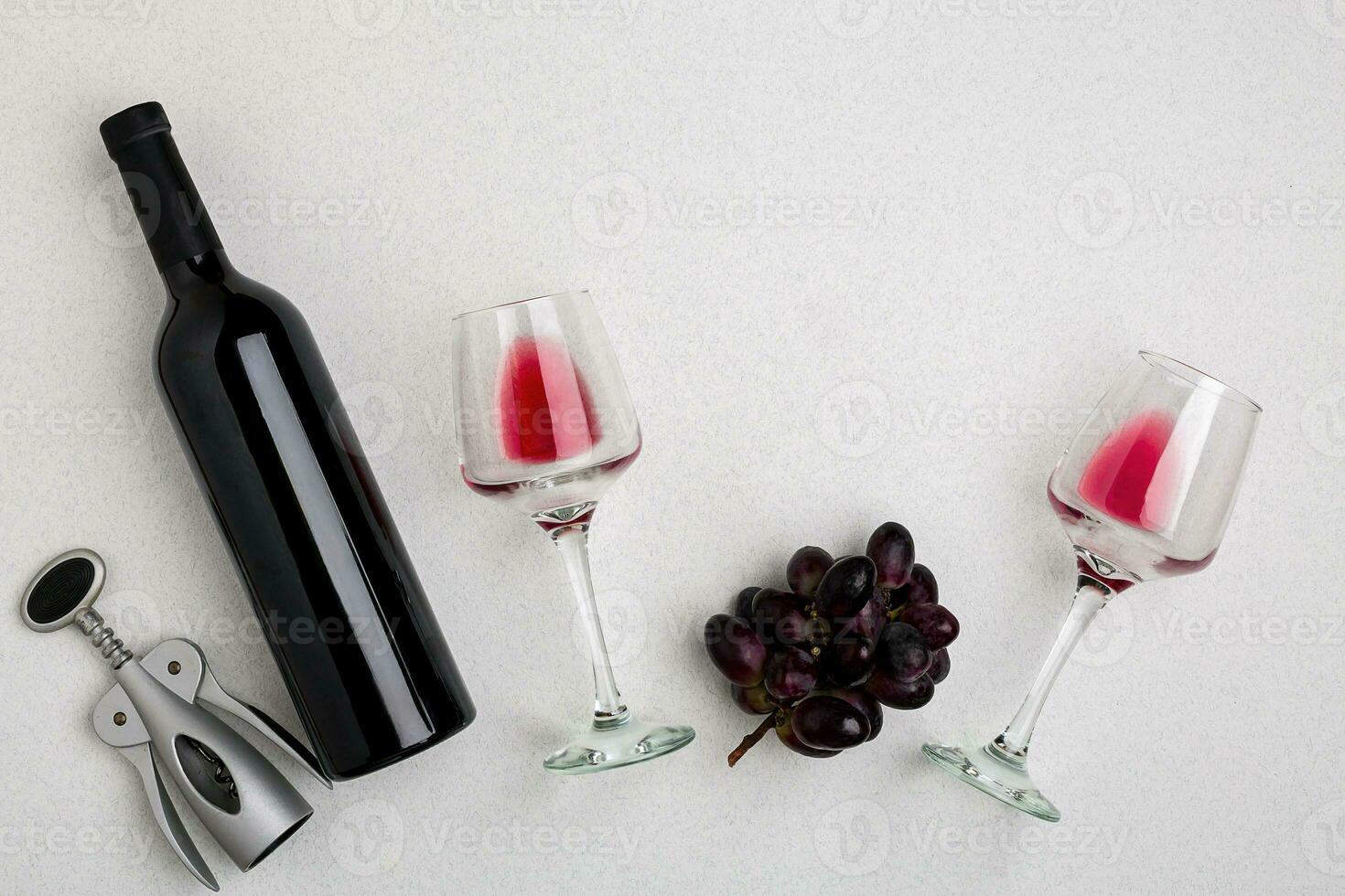 Red and white wine bottles and glasses, top view photo