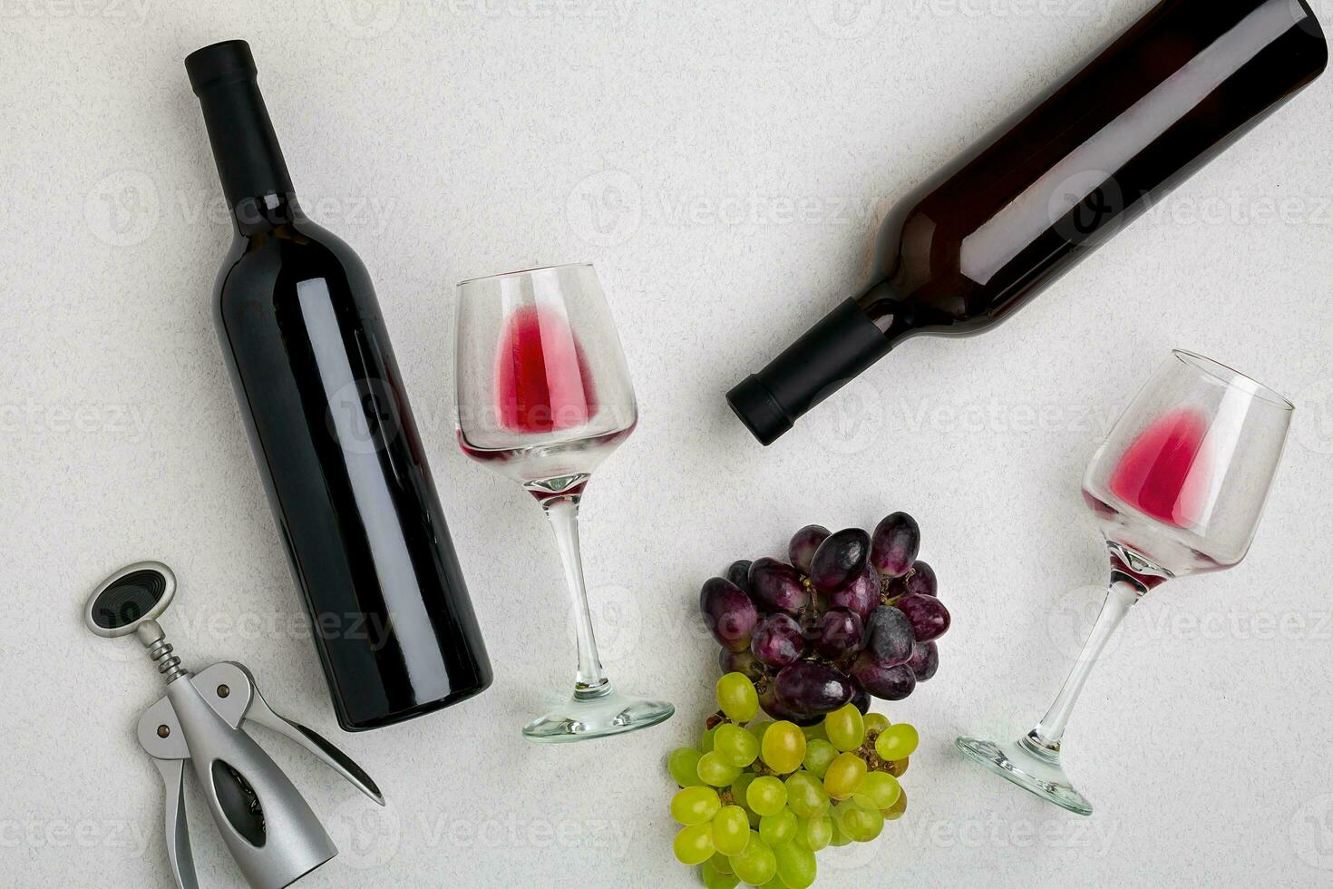 Two glasses of red wine and grapes. Top view photo