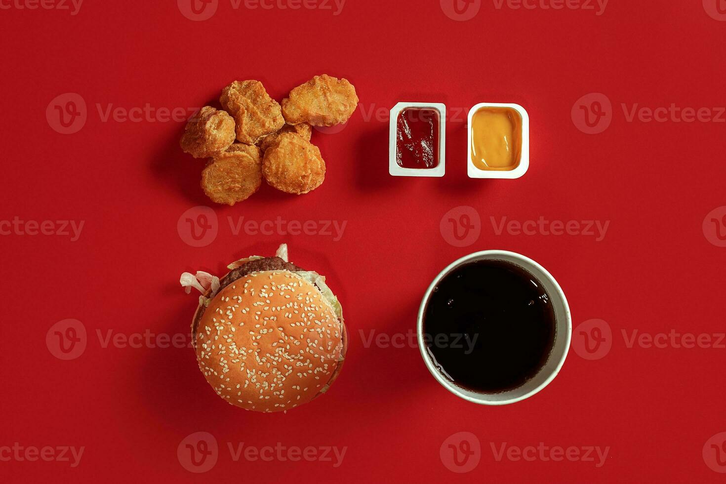 Burger and Nuggets. Fast food on red background. photo