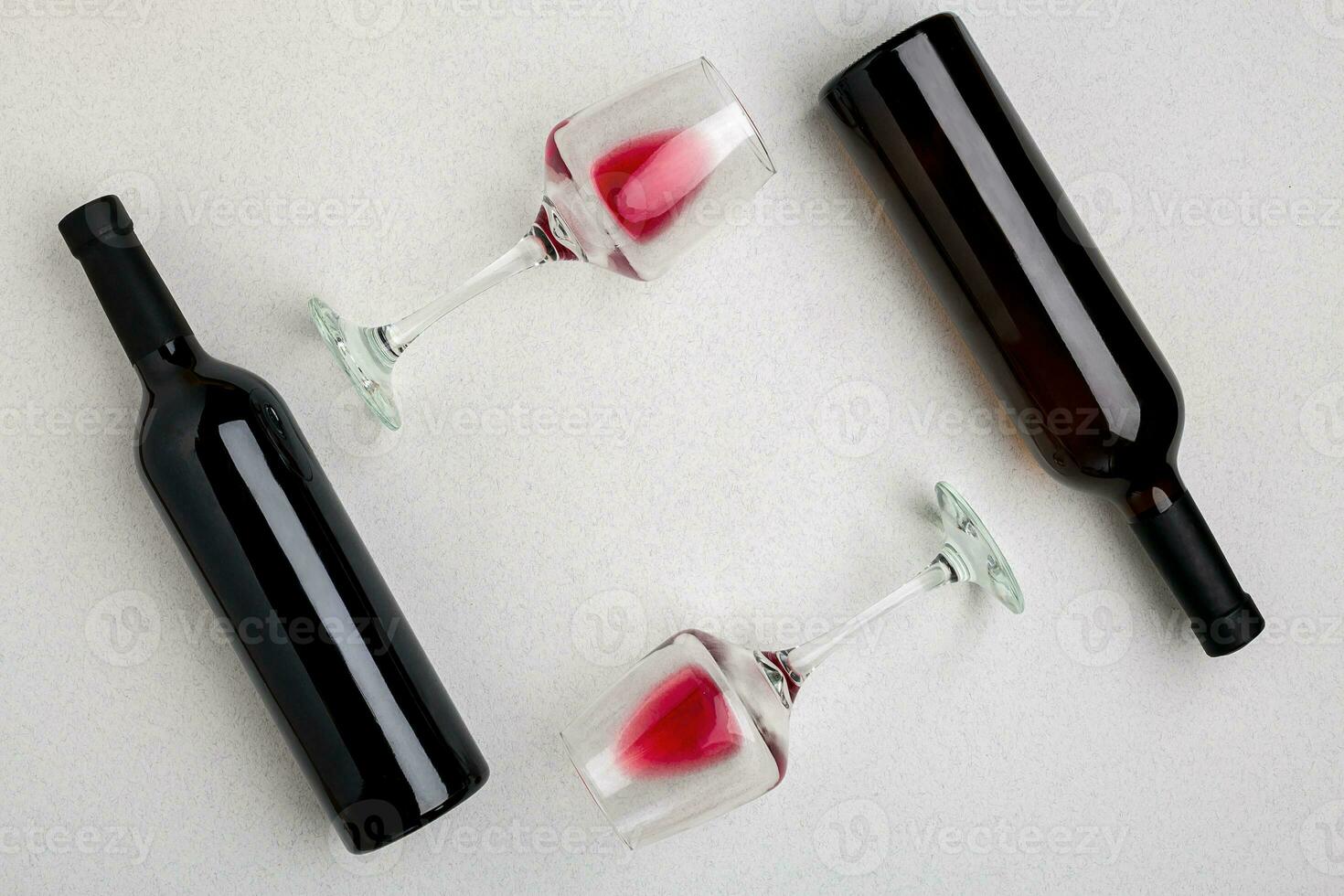 Red and white wine bottles and glasses, top view photo