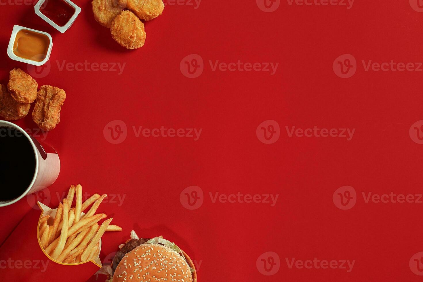 Burger and Chips. Hamburger and french fries in red paper box. Fast food on red background. photo
